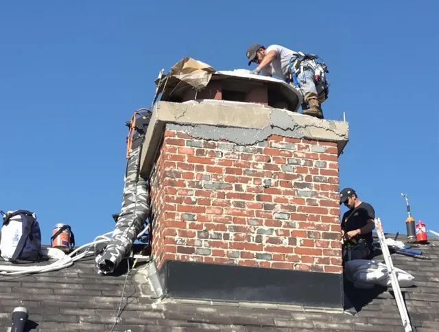 Abington Chimney Sweep installing a custom chimney crown in Abington, MA